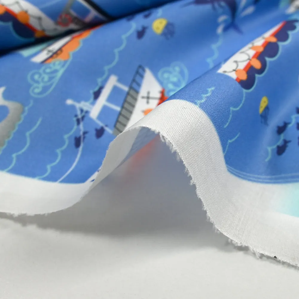 Coton imprimé l'océan et ses bateaux fond bleu